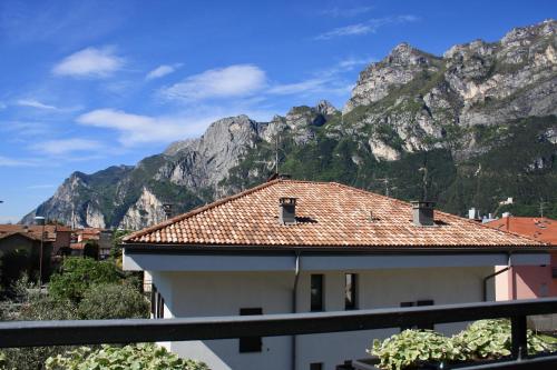 a building with a mountain in the background at Fortuna's quiet place in Riva del Garda