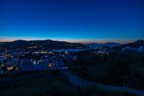 a view of a city at night at Ornos Blue in Ornos