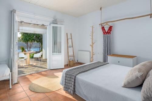 A bed or beds in a room at Ornos Blue