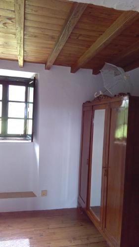 an empty room with a cabinet and a window at A Minguxaina in Ribadeo