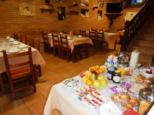 a table with food on it in a restaurant at Albergue Las Almunias in Las Almunias