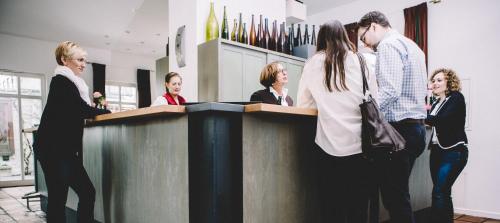 a group of people standing around a counter at Breuer's Rüdesheimer Schloss in Rüdesheim am Rhein