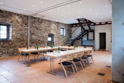 a large room with a long table and chairs at Breuer's Rüdesheimer Schloss in Rüdesheim am Rhein