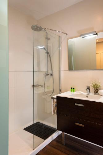a bathroom with a glass shower and a sink at Hotel de Francia y París in Cádiz