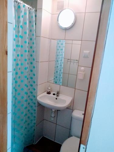 a small bathroom with a sink and a toilet at Pensjonacik Gafel in Ruciane-Nida