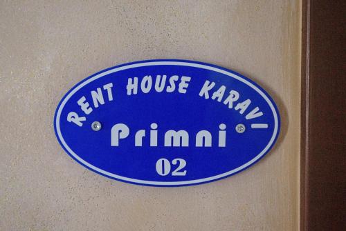 a blue sign on the wall of a room at Rent House Karavi in Iraklitsa