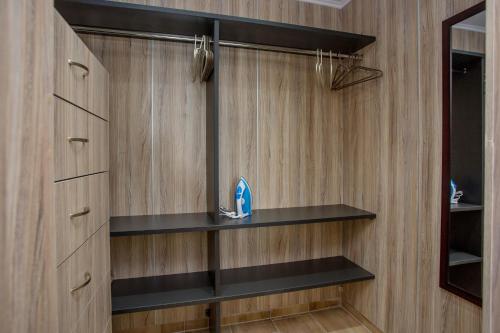 a bathroom with black shelves and a mirror at Rent House Karavi in Iraklitsa