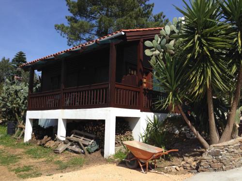 a house with a deck on the side of it at Redondo Lodges in Junceira