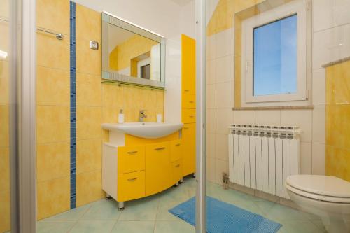 a bathroom with a sink and a toilet at Villa Nicole in Banjole