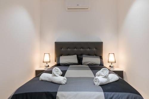 a bedroom with a large bed with towels on it at Calle de Felipe III, 7 in Madrid