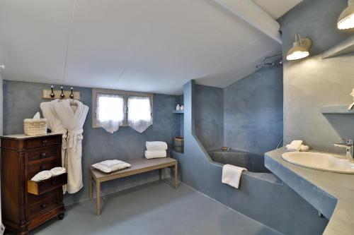 a bathroom with a sink and a toilet and a mirror at Le Mas Les Eydins in Bonnieux