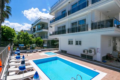 a swimming pool in front of a building at White Star Antalya in Antalya