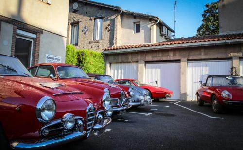 a row of old cars parked in a parking lot at Hostellerie Du Grand Saint Antoine in Albi