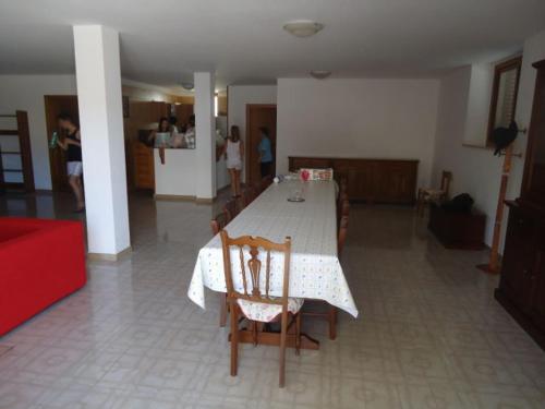 a dining room with a table and chairs in a room at VILLA GARDA HOUSE 42 in Marina di Mancaversa