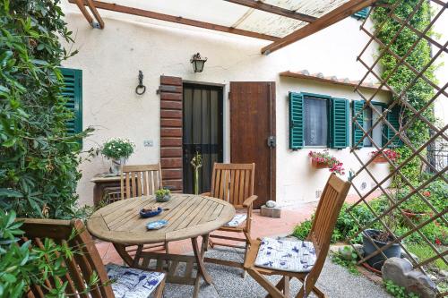 a patio with a wooden table and chairs at Chiantihouse near Florence in Montespertoli