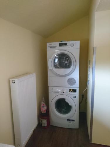 a washing machine and a washer in a room at Penzion Forest in Rozvadov