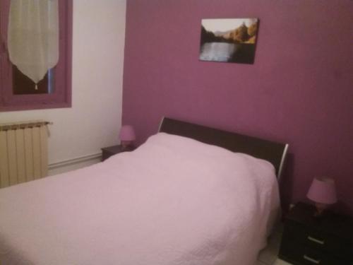 a bedroom with a white bed and purple walls at Villa Rue Gainekoa in Cambo-les-Bains