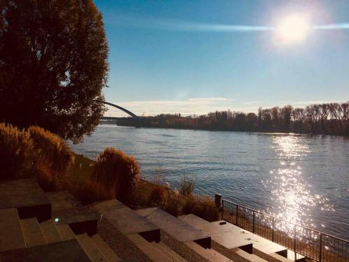 a view of a river with a bridge in the background at Second home in heart of Bratislava in Bratislava
