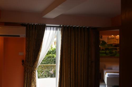 a window with curtains in a room with a bed at Eurotel Boracay in Boracay