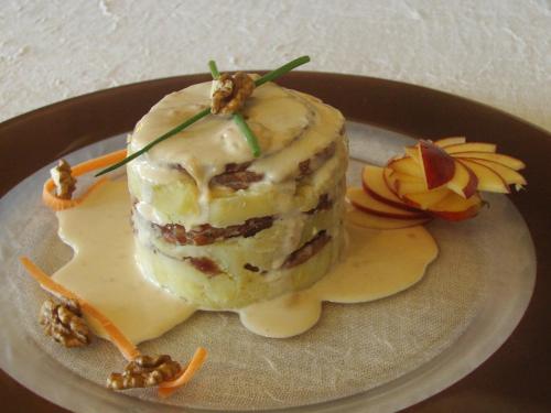 a piece of cake on a plate on a table at Logis- Hôtel & Restaurant Le Montligeon in La Chapelle-Montligeon