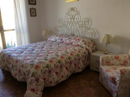 a bedroom with a bed with a floral bedspread at Residenza Guarna in Salerno