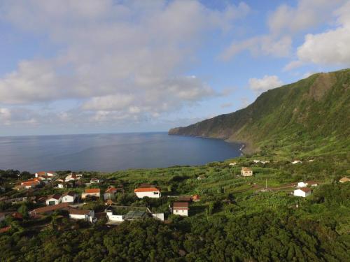 a view of a village and a lake in the mountains at Portugal House in Praia do Norte