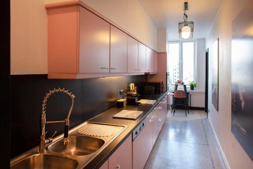 a kitchen with a sink and a counter top at #Groentemarkt1 in Ostend