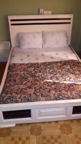 a bed with a bunch of leaves on it at Gya-son Royal Guest House in Kumasi