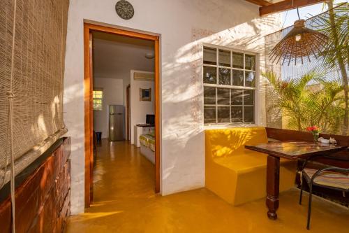 a living room with a yellow couch and a table at The Dive Hut - Boutique Apartments in Kralendijk