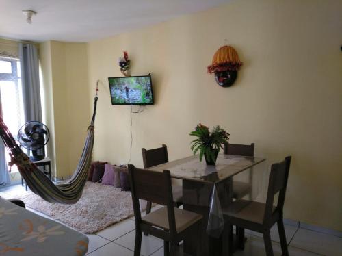 a dining room with a table and a hammock at Recife Centro Apartamento in Recife