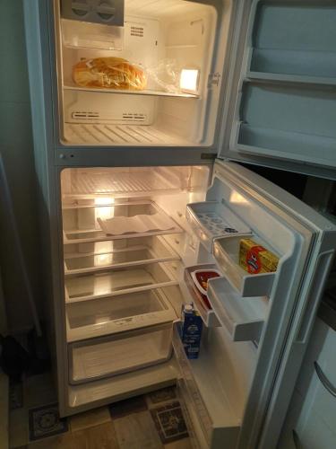 a refrigerator with its door open with food inside at Meyenburg Units in Mount Morgan