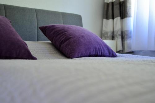 a purple pillow sitting on top of a bed at Palatium Bad Ems in Bad Ems