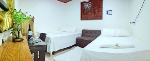 Uma cama ou camas num quarto em Hotel Ciudad Blanca