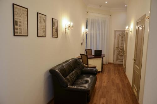 a living room with a leather couch and a desk at Apartment nr. 8 in Odesa