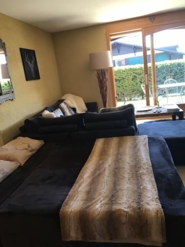 a living room with a couch and a wooden table at Apartment with Garden Daltons 1 in Crans-Montana