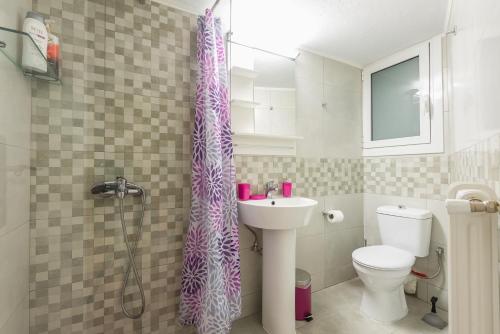a bathroom with a purple shower curtain and a toilet at Zenios Ippokratis-Comfort & style, Athens downtown in Athens