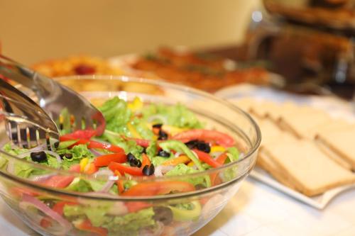 a salad in a glass bowl on a table at Vamos Addis Hotel in Addis Ababa
