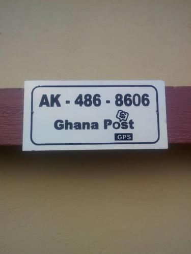 a sign hanging from the ceiling of a building at Gya-son Royal Guest House in Kumasi