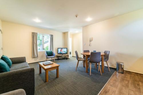 a living room with a couch and a table at City Centre Motel in Christchurch