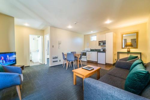 a living room with a couch and a table at City Centre Motel in Christchurch