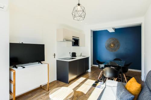 un salon avec un canapé et une télévision dans l'établissement Rossini Centre Ville - Proche Tram, à Nice
