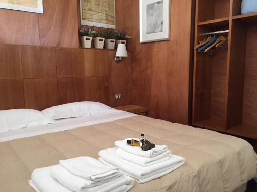 a bed with towels and a camera on top of it at Campo Reale country rooms in Pachino