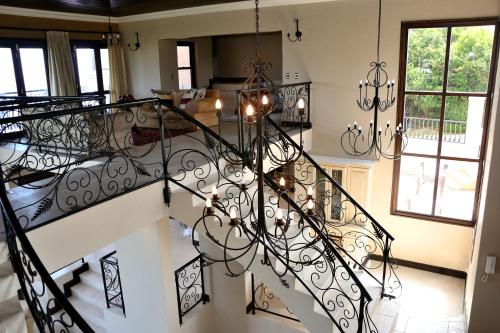 a spiral staircase in a home with a chandelier at Villa Seaview in Knysna