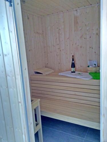 a bottle of wine sits in a sauna at Reusenhaus Süd in Breege