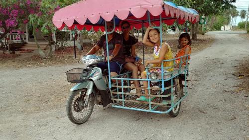 a group of people riding in a motorcycle cart at Wandee Resort Bankrut in Ban Krut