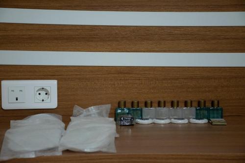 a row of bottles and bags on a wall at Sogutpark Hotel in Trabzon