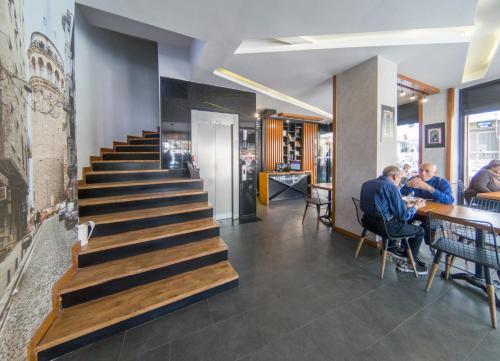 a group of people sitting at tables in a restaurant at Grand Esen Hotel in Istanbul