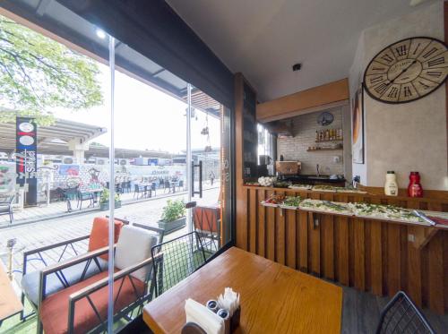 a restaurant with a clock on the wall and a table at Grand Esen Hotel in Istanbul