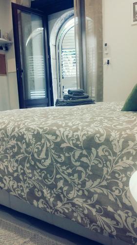 a bedroom with a bed with a design on it at Casa Cleone in Taormina