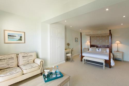 a living room with a couch and a bed at La Fregate Hotel in St Peter Port